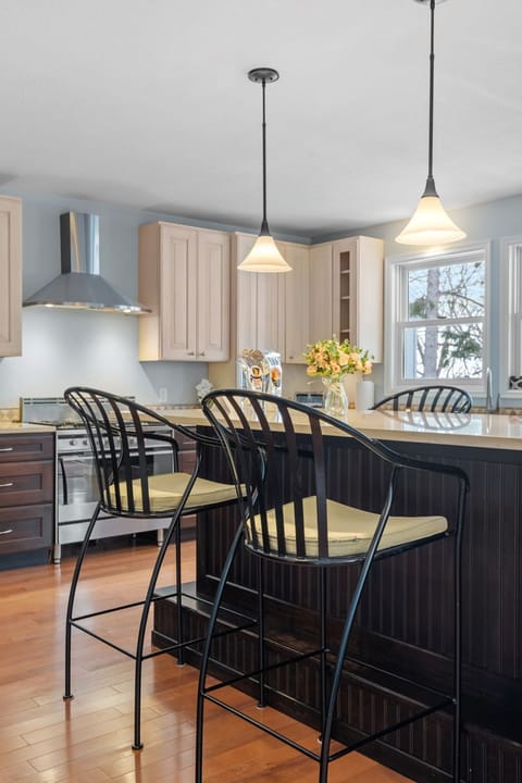 Your dream kitchen awaits with stylish pendant lighting, modern bar seating, and everything you need to create memorable meals together.