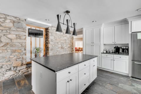 Kitchen: Cook up a feast in this stylish space with sleek counters and charming stone accents!