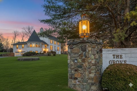 Welcome to The Grove! Enchanting stone entrance welcomes you to an unforgettable getaway under vibrant skies!