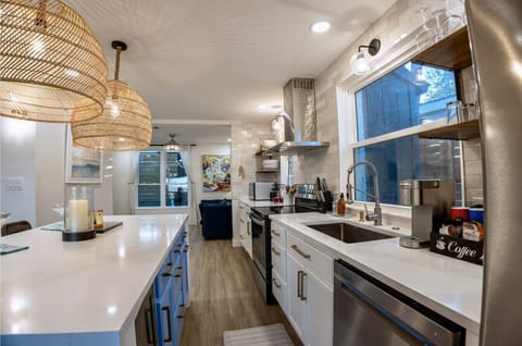 Modern kitchen features a French door refrigerator and a built-in wine fridge—perfect for relaxing in style