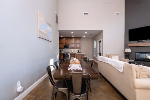 Large dining room table with additional seating at the bar.