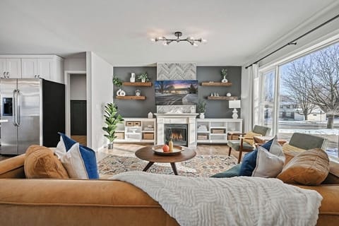 Relax in the spacious living room with plush seating and a cozy fireplace.