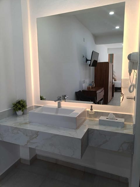 Family Studio Suite | Bathroom | Shower, hair dryer, towels, soap