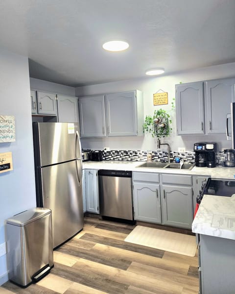 Fully stocked kitchen with modern appliances and coffee bar.  