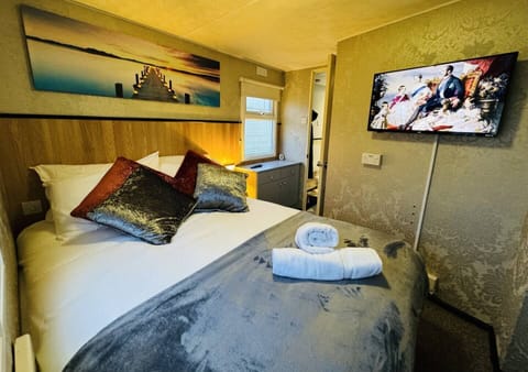 Comfortable double bed with soft pillows and a flat-screen TV for your convenience.