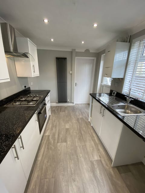 Bright and modern kitchen with sleek countertops, ample storage, and all essentials for a comfortable stay.