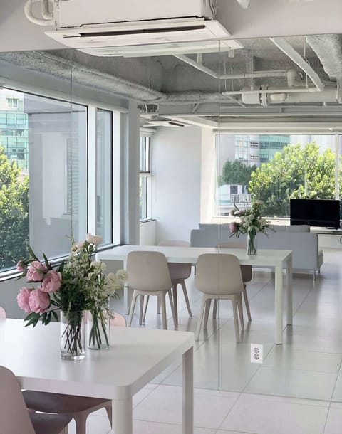Spacious living room with a sofa and a table for dining or work.  Great setup for working from home. 