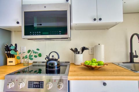 Start your day with a warm cup of tea or a quick bite in this thoughtfully designed kitchenette.