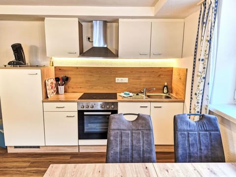 Furniture, Interior Design, Flooring, Wood, Floor, Cabinetry, Room, Countertop, Kitchen, Major Appliance