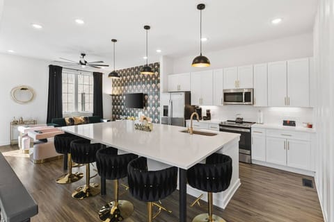 Open floor plan from the kitchen to living room, equipped with comfortable furnishings, plenty of natural light and all the kitchen essentials you would need. Plenty of seating for dining at our huge kitchen island.