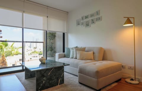 Bedroom with sitting area and lamp.