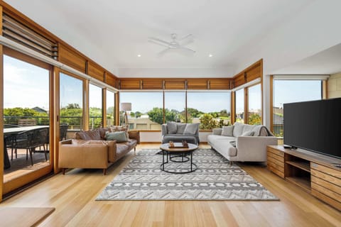 Stunning lounge room located upstairs with large, flat screen TV, ample seating, views of Torquay and direct access to the outside deck, kitchen and dining room. 