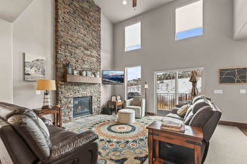 Retreat 13548: Main-mid living area with comfy seating, cozy fireplace, TV and lots of light.