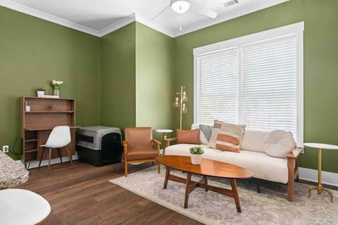 Living room couch folds out into full-sized bed. Dog crate featured in the living room for guests traveling with pets 