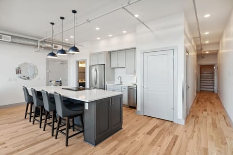 Kitchen: Full bathroom to the left of the fridge. Laundry in closet to the left of the hallway. Hallway leads you to master and main floor bedroom #2, as well as the staircase to the private loft.