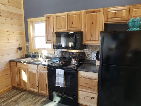 Fully Equipped Kitchen with full size stove/oven, microwave and fridge.