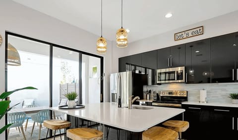 The kitchen is a chef’s dream, featuring modern appliances and plenty of space for cooking and entertaining.