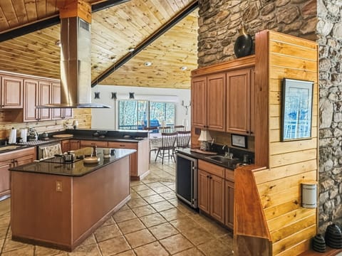 Spacious Tiled Kitchen with Granite Counters and Wine Chiller