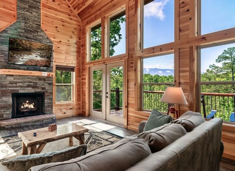 Spacious open-floor concept with vaulted ceiling and floor-to-ceiling windows.