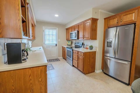 Kitchen area with refrigerator, stove and sink