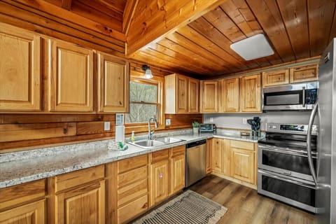 Spacious countertops, custom wood cabinets, and warm natural light make this kitchen both functional and inviting.