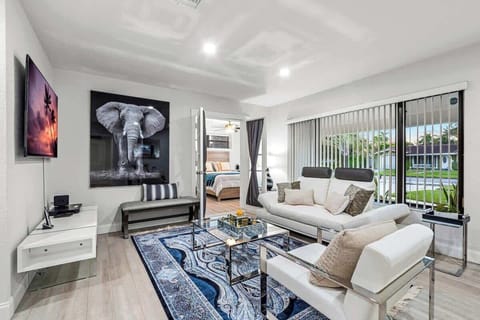 Living room with sectional seating and a smart TV, open to the dining area.