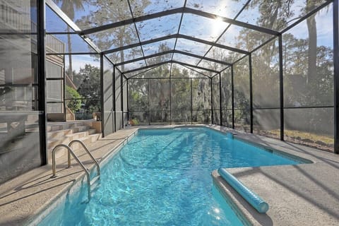 Soak up the sun in this beautiful screened-in pool. 
