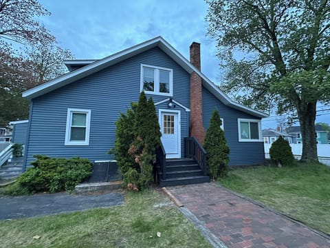 Charming blue coastal cottage with a private entrance and brick walkway. Located in a quiet, walkable neighborhood near Old Orchard Beach with free onsite parking included