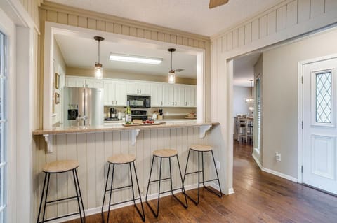 Modern kitchen with a bar-top seating area, perfect for casual meals, socializing, or enjoying a morning coffee