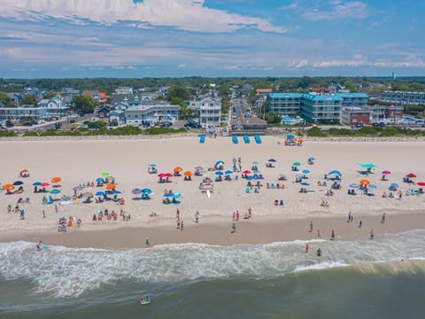 Stunning beachfront with golden sand and vibrant beachgoers—enjoy the best of Cape May right outside your door.