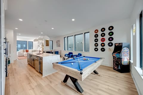 Pool table and arcade machine in the game room turn rainy afternoons into tournaments. The open kitchen island nearby means snacks and drinks flow easy between rounds