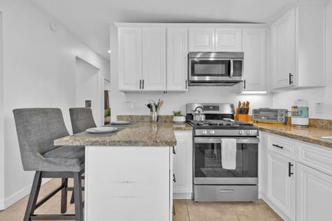 Fully stocked kitchen with blender, huge pots and coffee maker