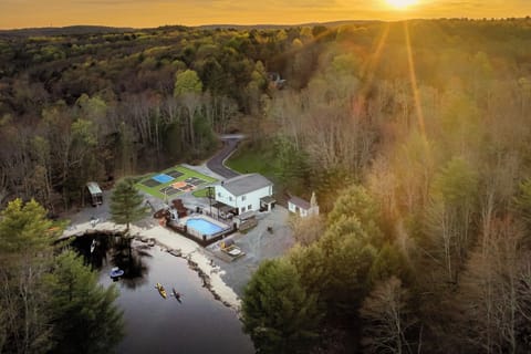 Aerial view of your 7-acre estate with private lake, pool, and trails.