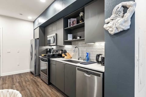 A sleek, fully equipped kitchen with stainless-steel appliances and smooth cabinetry — ideal for both short stays and gourmet evenings.