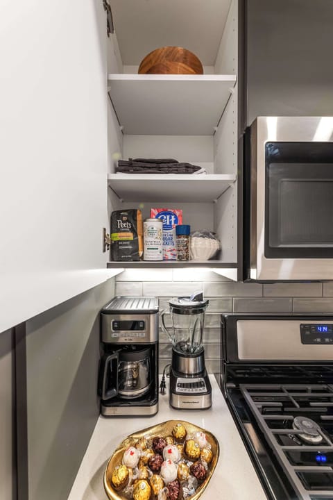 A barista-ready setup with coffee maker and blender — your morning ritual starts in style.