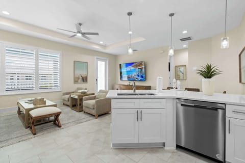 kitchen stocked with bar glasses, blender and a shaker set
