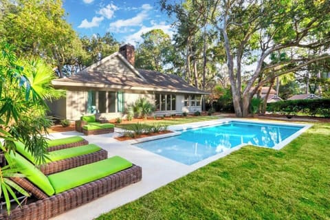 Backyard Pool Private pool with sun deck for lounging and play, surrounded by mature trees offering both sun and shade