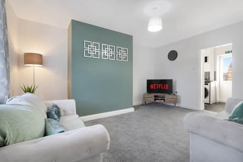 Thoughtfully designed for comfort, the living room includes a Smart TV and plenty of seating, offering the perfect spot to unwind, read a book, or enjoy a relaxing evening.