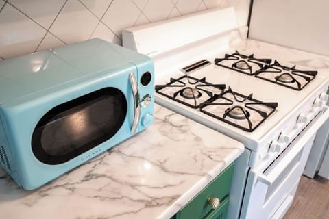 Retro microwave and natural gas stove/oven.