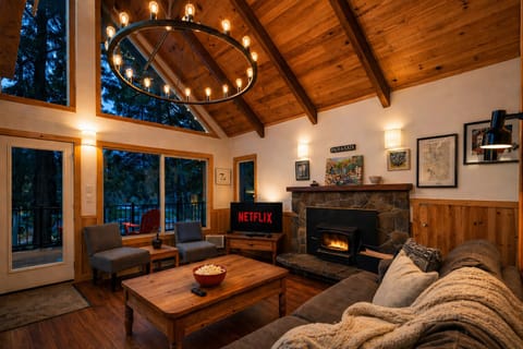 Rustic wood beams and warm lighting create the perfect atmosphere for cozy movie nights.