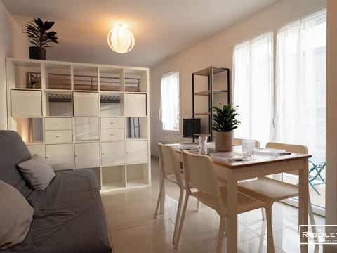 Large living room with sofa and dining table. 