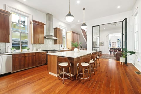 Open layout from kitchen through steel doors into family and living rooms.