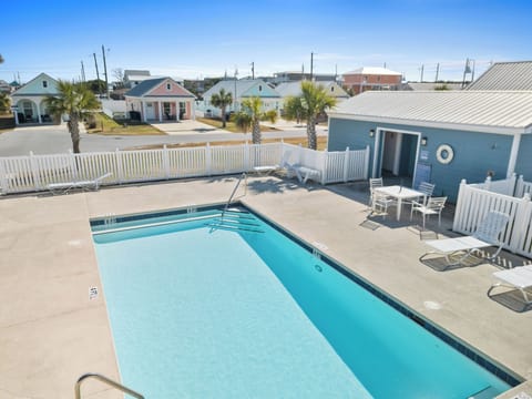 Dive into your private pool oasis surrounded by tropical palms and coastal charm in this beachside community.