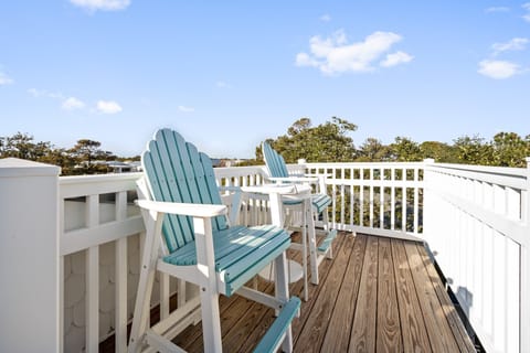 Unwind on your private deck with comfortable Adirondack chairs overlooking lush treetops and blue skies.