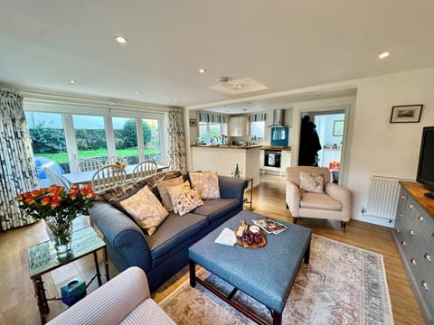 Open plan sitting room with wood burner