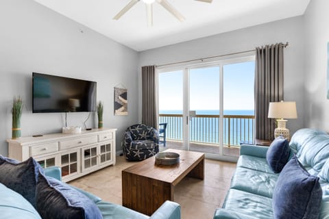 Living Room - Kick back in this bright living room with a comfy sofa and love seat, and a large comfy chair—ample seating for family and friends, with a queen sleeper sofa.