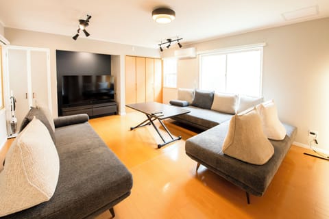 Villa | Living area | 65-inch flat-screen TV with cable channels, offices