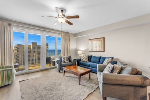 Relax in this bright living room with ocean views through large glass doors.