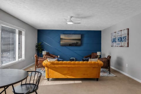 Bright yellow couch paired with a calming blue wall creates a stylish, relaxing space.