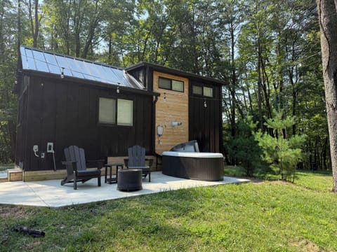 Yeats exterior with hot tub and fire pit — personal hot tub on the deck, fire pit area ready for the evening, Adirondack seating